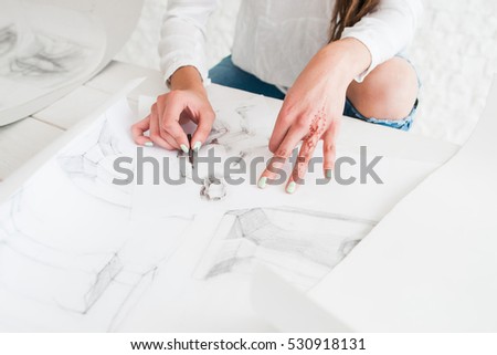 Artist hands drawing sketch on whatman or white paper. Female painter painting in studio. Stylish woman with mehendi oh hand working in workshop. Art, talent, craft, hobby, creativity concept