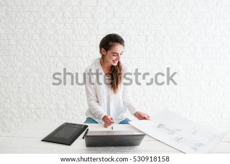 Smiling woman at workplace, free space. Glad designer retouching sketch on laptop. Happy artist satisfied of her work. Art, talent, craft, hobby, work, creativity concept