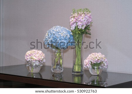 The veses of flowers are on the wedding table
