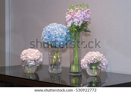 The veses of flowers are on the wedding table
