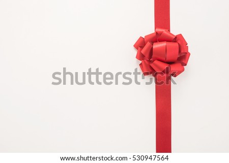 Decorative red ribbon and bow on a white background