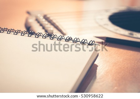 Concept of music, Notebook on guitar for writing music,Vintage retro picture style.