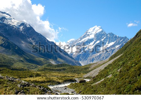 The majestic view of Mount Cook, New Zealand's highest mountain, approaching on the hiking trail through Hooker Valley. Royalty-Free Stock Photo #530970367