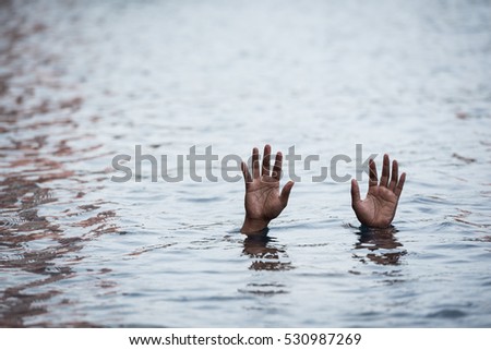 Hand in water asking for help in  rescue concept.