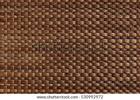 Bamboo woven brown mat handmade background. Wicker wood texture. Horisontal strips.