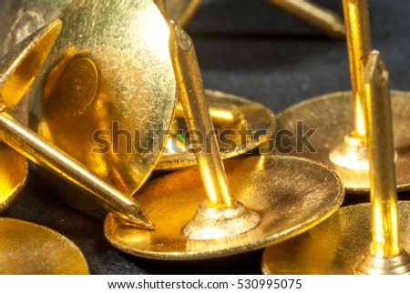 Golden drawing (push) pins background. Thumbtacks stock