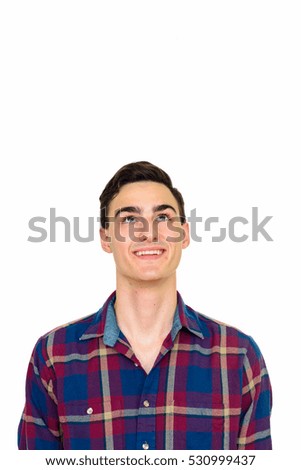 Studio shot of young happy Caucasian man looking up isolated against white background