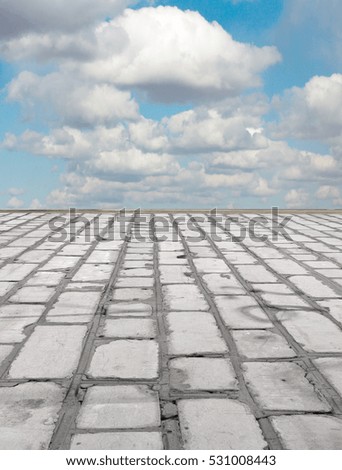 old brick road on the blue sky background