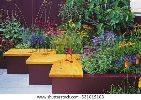 Small garden seating idea with Colourful planting in an urban garden 