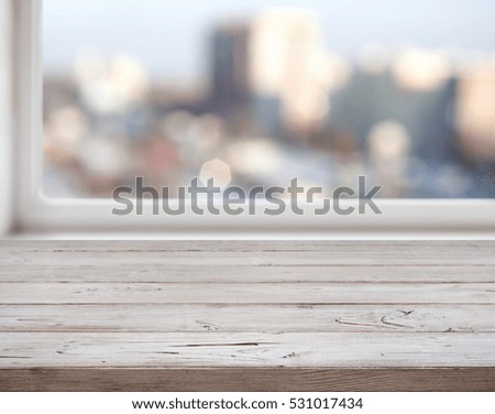 Wooden texture planks on abstract city lights background.