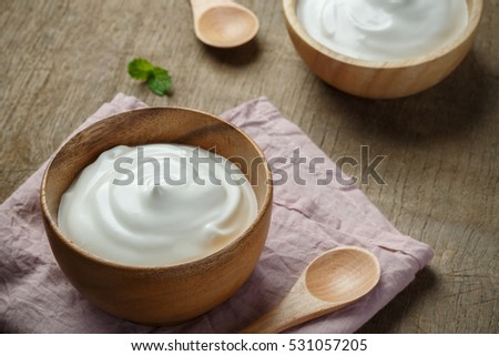 Homemade yogurt or sour cream in a wooden bowl, Health food from yogurt concept