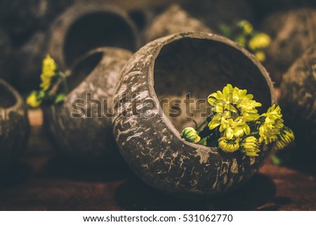 Vintage tone Yellow flowers in Coconut shell 