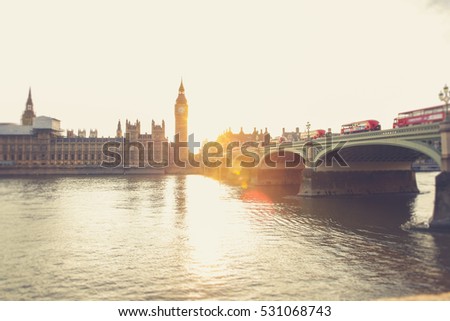 Silhouette of Big Ben and Westminster palace in London at sunset with sun in the background