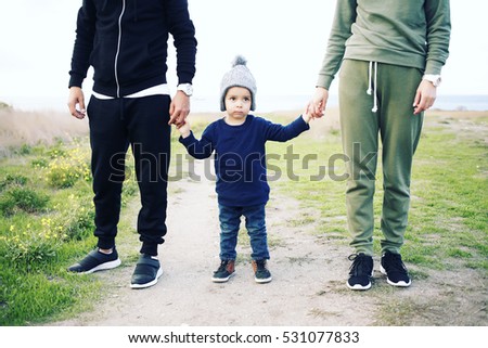 Young happy family having fun together outdoor. Parents enjoying life together. Happiness and harmony. Lifestyle. Photo toned style instagram filters