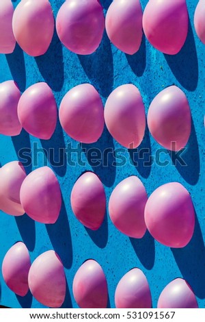 Atraktsion with balloons at the fair. a brightly colored rubber sac inflated with air and then sealed at the neck, used as a children's toy or a decoration.