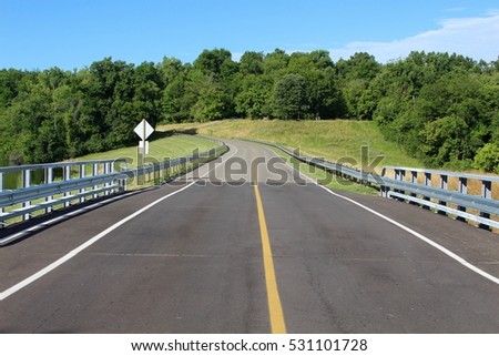 A empty road on a bright sunny day.