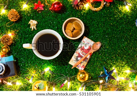 Coffee Break and mini cookies in Christmas day on green grass. Morning sunshine day and good day. Happy time together in winter season.Top view