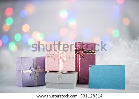 Colorful gift boxes on the white fur with copy space for season greeting Merry Christmas or Happy New Year.