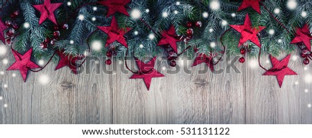  Christmas ornament border with snow on a rustic wood background.