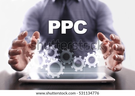 Businessman is using tablet pc and selecting ppc.