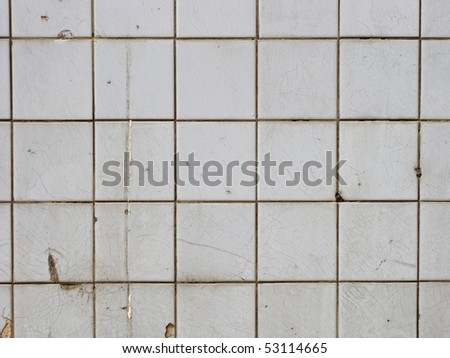 wall with worn white tiles