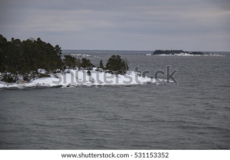 Finland, Helsinki, late autumn. Baltic sea, bay. Still water of the gulf, islands with forests.