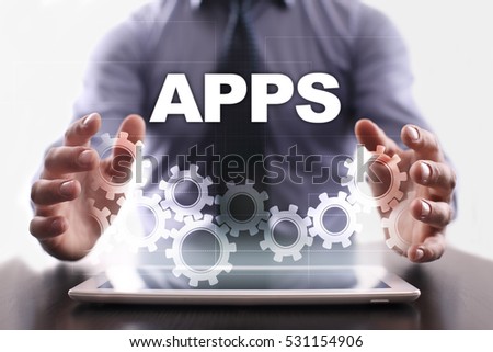 Businessman is using tablet pc and selecting apps.