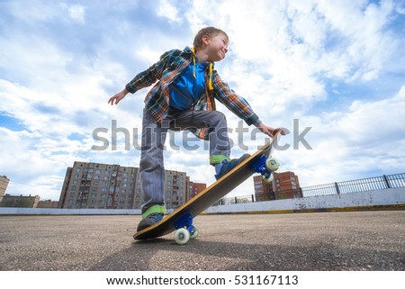 Happy child is going to skateboarding - people, sport and skateboard concept. 