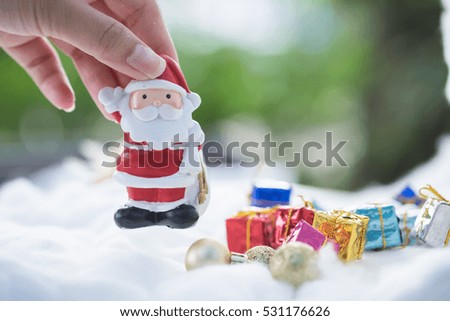 Female's hand and colorful Christmas characters and decorations. Using as wallpaper or backgrounds.