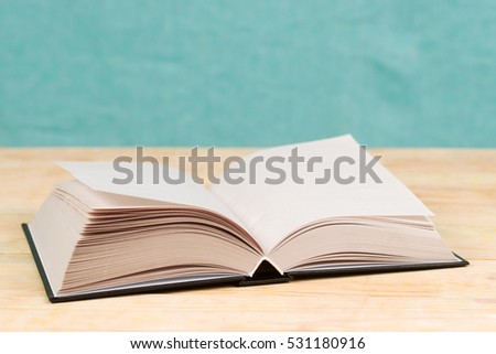 Open book on wooden table. Back to school. Copy space. Top view.