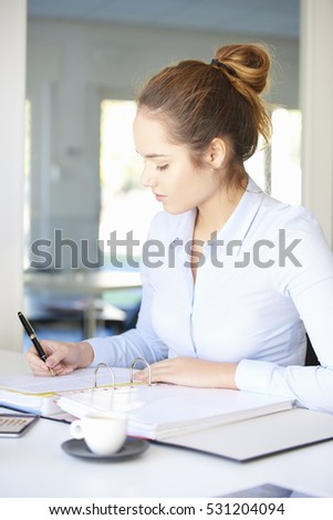 Shot of a young businesswoman sitting at desk and sign the contract.