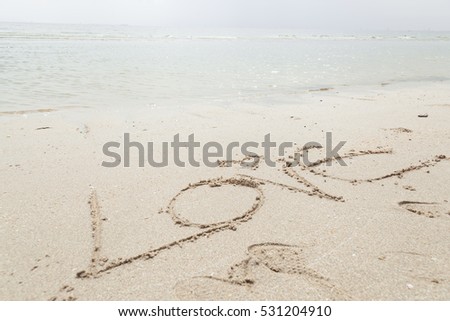The love message written in sand and sea