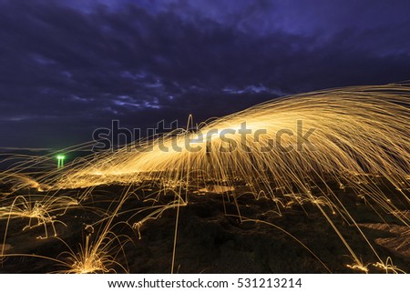 Steel wool spinning, fire shower concept abstract background.