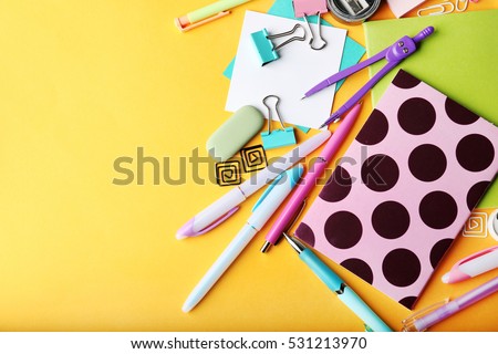 Colorful stationery on yellow background Royalty-Free Stock Photo #531213970