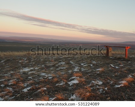 The lonely bench on the hill in the winter / bench on the hill