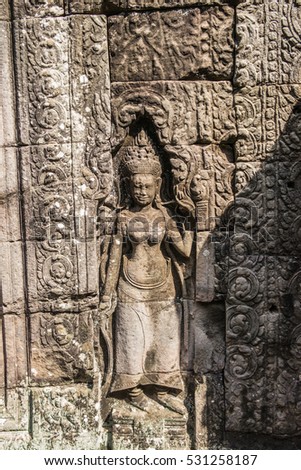 Khmer classical dancers shown in stone - An Apsara (also spelled as Apsarasa) in Banteay Kdei temple in Angkor, Siem Reap, Cambodia.