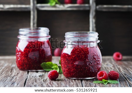 Homemade jam with raspberry on the wooden table, selective focus Royalty-Free Stock Photo #531265921
