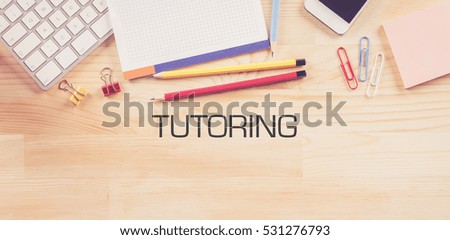 TUTORING Concept on Wooden Background