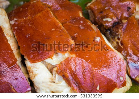 Juicy pork meat cooked on grill. Sliced pork barbecue with gold skin. Spanish dish lechon close image for restaurant menu or eatery illustration. Tasty meat ready for eat. Traditional cuisine of Spain