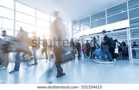 blurred people walking in a modern European Trade Fair hall