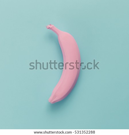 Pink banana on blue pastel background. Minimal style. Flat lay. Food concept.