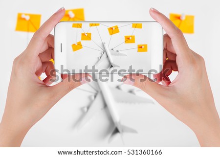 Woman hand using smart phone taking photo for preparation traveling network with push pin, string and paper noted. Travel concepts, Ambient blurry background.