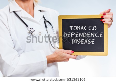 Tobacco Dependence Disease Written On Chalkboard Sign Held By Female Doctor.