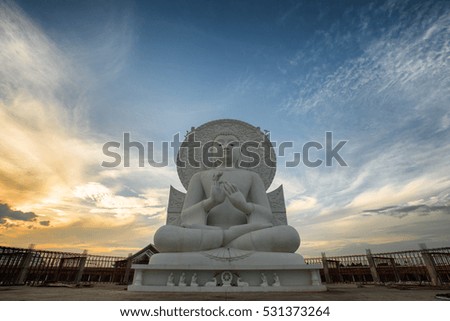 Big Buddha statue white stone on the sunset in Thailand