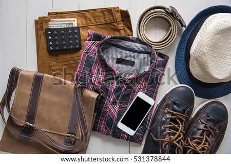 Flat lay of men's casual fashion on white wooden floor