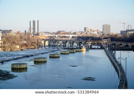 Mississippi river between St. Paul and Minneapolis twin cities in Minnesota during sunset. Canal lock to elevate boats in wide shot