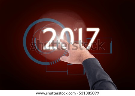 Businessman pointing with his finger against red background with vignette