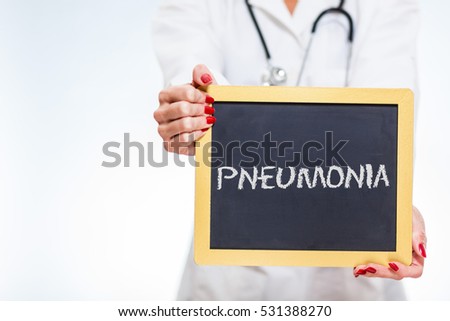 Pneumonia Written On Chalkboard Sign Held By Female Doctor With Copy Space.