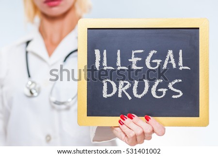 Illegal Drugs Chalkboard Sign Held By Female Doctor.