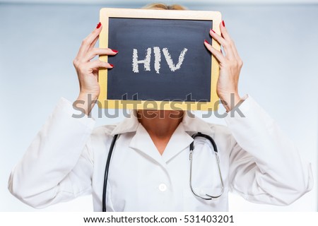 HIV Chalkboard Sign Held By Female Doctor In Front Of Face.
